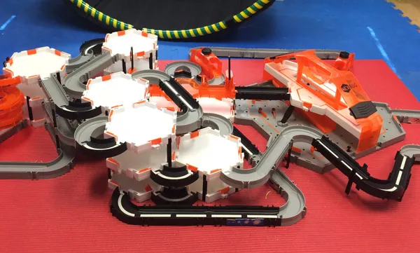 Toy trucks on a road track built across the therapy mat
